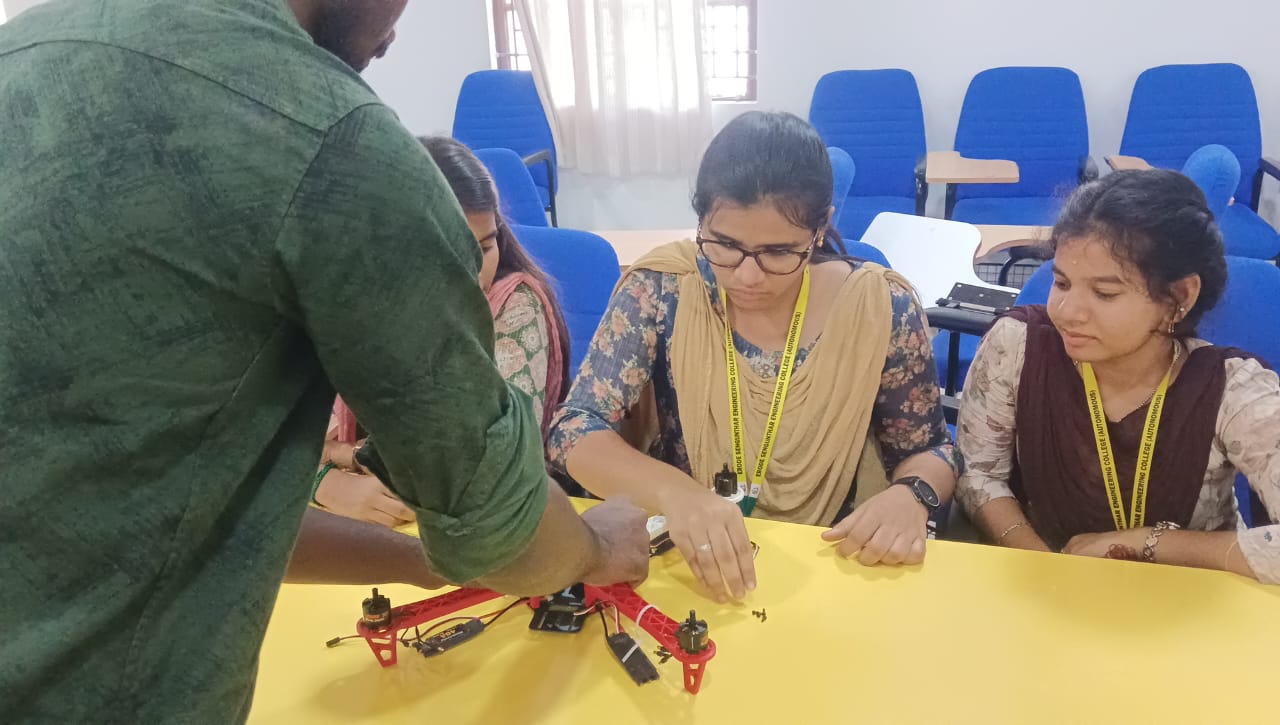 On a yellow background, a digital watch and a glass.
